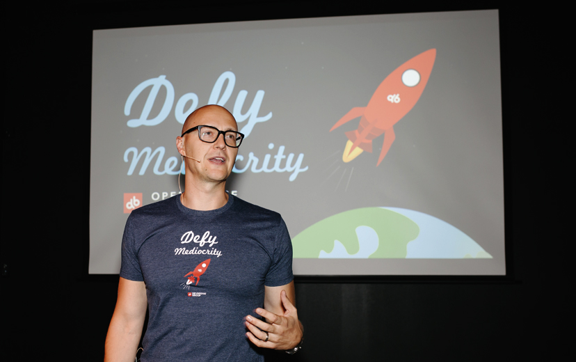 Aurimas gives a presentation on defying mediocrity